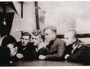 A group of sailors listening to a message from the mainland, 1944 г.